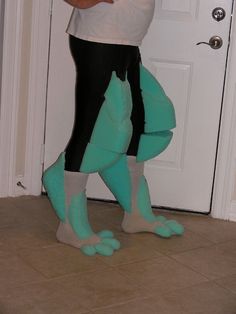 a woman is standing in front of a door with her feet on the ground while wearing green socks