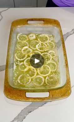 a glass dish filled with lemon slices on top of a counter