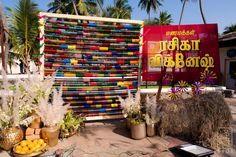 there is a sign that has been made out of plastic bottles and other things on display