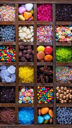 a wooden box filled with lots of different types of candies