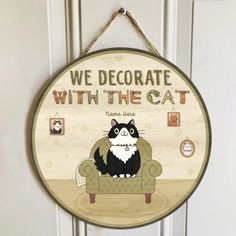 a wooden sign that says we decorate with the cat