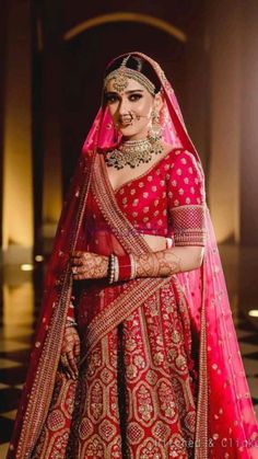 a woman in a red and gold bridal gown