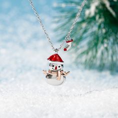 With a red hat and an orange scarf, this adorable snowman necklace is loved by all who see it. Lovely Christmas snowman design is fashionable and chic. Let you look more charming and attractive. This lovely snowman pendant would make a perfect little gift for anyone who's dreaming of a white Christmas.Carat Weight: 0.05 ctStone Size: 1 mmStone Type: Jeulia® StoneNumber of Stones: 2 Stone Color: Fancy BlackStone Shape: RoundWeight: 4.62 gWidth: 11.7 mmHeight: 18 mmThickness: 5 mmMaterial: 925 Sil Winter Gift Red Jewelry, Winter Season Red Jewelry Gift, Red Jewelry For Winter Gifts, Snowman Jewelry, Snowman Necklace, Sliver Necklace, Dreaming Of A White Christmas, Snowman Design, Orange Scarf