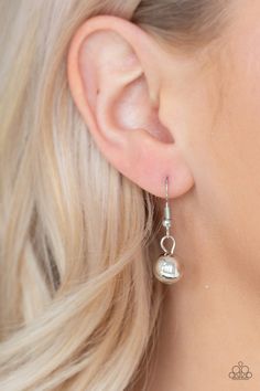 a close up of a person wearing earrings with pearls on it's sides and the back of their ear