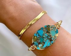 **Each piece in my shop, I personally create and photograph. (All photos are property of The Cord Gallery LLC) Thank you for supporting my small business. Genuine Mojave Turquoise Slice Bracelet Raw Brass Cuff Restocked! These turquoise cuffs finish off any outfit perfectly! Each raw turquoise stone is oval cut and electroplated in gold trim including gold veining throughout. Some cuffs will have quartz in them as well - super cool looking! Finished off with a raw brass cuff that is slightly adj Turquoise Natural Stone Cuff Bangle, Turquoise Bangle Cuff Bracelet With Natural Stones, Raw Turquoise, Brass Cuff, Cuff Jewelry, Bangles Jewelry Designs, Turquoise Bracelet Cuff, Gold Bracelet Cuff, Turquoise Cuff