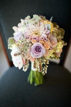 a bouquet of flowers sitting on top of a chair