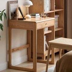 a wooden desk sitting next to a bed in a room with bookshelves and a lamp