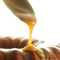 a bundt cake is being drizzled with icing