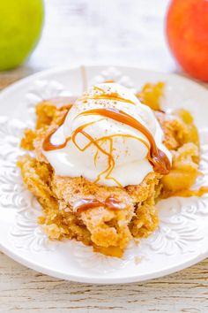 a piece of cake on a plate with ice cream and caramel drizzle