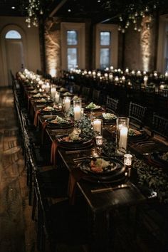 a long table is set with candles, plates and place settings for an elegant dinner