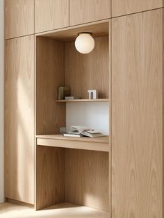 a wooden shelf with some books on it and a light bulb hanging from the ceiling