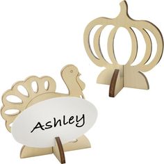 two wooden turkeys with the word ashley written on one side and an acrylic turkey on the other