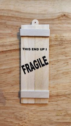 this end up is fragile on a piece of wood with the word fragile printed on it