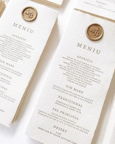 the menus are laid out on top of each other, with gold foil stamping