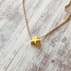 A petite tiny beautiful shiny gold star necklace pendant .Very tiny necklace elegant and cute, a perfect gold necklace for every day wear. Simple, dainty and classic! Necklace Measures Approximately 17"Made from 14k gold filled chain and lobster claps You can adjust the size on request.All my jewelry are packed in an elegant gift box.If you want to give it as a gift you can specify the address and I'll be happy to send it on your behalf.To see more, please visit my shop at :  http://www.etsy.com Minimalist Gold Necklace With Star Of David, Simple Tiny Gold Charm Necklace, Minimalist Star Charm Necklace, Delicate Star Charm Necklace For Everyday, Everyday Delicate Star Charm Necklaces, Tiny Star Shaped Minimalist Necklaces, Minimalist Star Charm Necklace With Delicate Chain, Dainty Star Charm Necklaces, Dainty Star Necklace For Everyday Wear