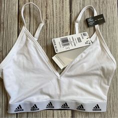 Adidas Training Aeroready Light Support Bra Size Xs White / Black Logo Brand New With Tags Size Xs Stretchy Material Adjustable Straps Fast Shipping! White V-neck Bra Friendly Tops, White V-neck Bra-friendly Tops, White V-neck Top Bra Friendly, White V-neck Tops, Bra Friendly, Cotton Workout Bra, White Sports Bra With Built-in Bra For Loungewear, White Cotton Sports Bra With Built-in Bra, White Medium Support Top For Loungewear, White Medium Support Tops For Loungewear