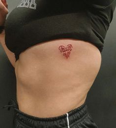 a woman's stomach with a tattoo on her lower back that says trust me