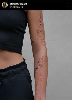 a woman's arm with tattoos on it