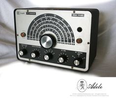 an old radio sitting on top of a white sheet with buttons and knobs in front of it