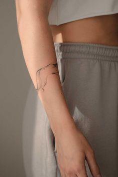 a woman's arm with a small elephant tattoo on the left side of her right arm