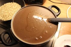 there is a pot on the stove with some food in it next to other pots