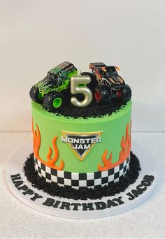 a monster truck birthday cake with flames and black frosting on the top is for five year old