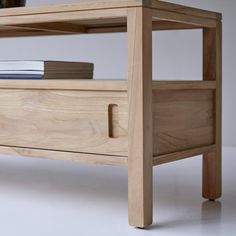 a close up of a wooden shelf with books on it's top and bottom