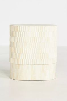 a white vase sitting on top of a table