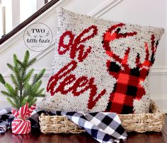 a christmas pillow sitting on top of a wooden table