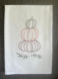 a white towel with an embroidered pumpkin on it