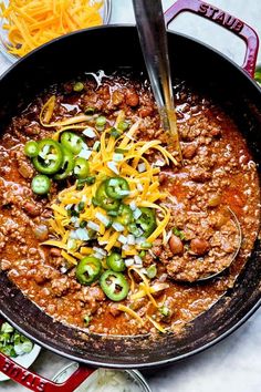 a skillet filled with chili and cheese