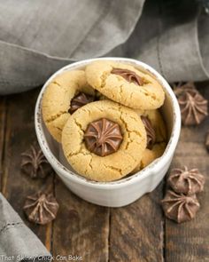 some cookies are in a white bowl with chocolate