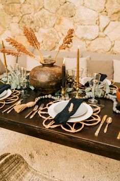 the table is set with black and gold place settings