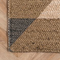 a close up of a rug on a wooden floor with wood floors and brown carpet