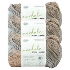 three skeins of yarn in grey and beige colors with the words nandal written on