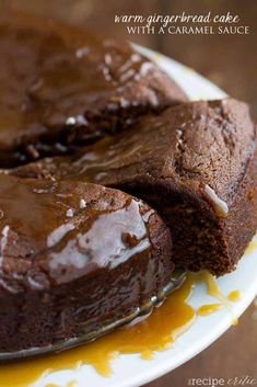 chocolate cake with caramel glaze on a white and yellow plate sitting on a wooden table