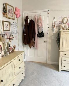 a room filled with lots of clutter and furniture next to a wall mounted coat rack