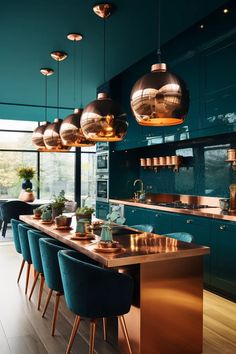 a kitchen filled with lots of blue chairs and copper lights hanging from the ceiling above it