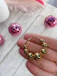 😍 Golden Bubble hoops 🎁 Add a graceful touch of elegance to your look with these modern beaded hoops.  ♥ MATERIALS ♥ 35MM 18K Gold plated brass round hoops Lightweight earrings ♥ ITEM DETAILS ♥ All of our bracelets are made from sturdy stretchy jewelry elastic. The listing is for one bracelet, images showing more than one are an example of how they would look stacked with other bracelets. If you have any questions, please feel free to message me. Please, make sure to measure your wrist before ordering as these are made-to-order custom bracelets, all sales are final. ♥ CARING TIPS ♥ Keep your jewelry dry and away from perfumes or any harsh chemicals Store your jewelry separately, and avoid wearing it if you are going to work out. Thank you so much for visiting my shop! Have fun creating y Yellow Gold Beaded Hoop Earrings For Gift, Elegant Gold Beaded Hoop Earrings, Gold Beaded Hoop Earrings For Party, Gold Hoop Earrings With Beads For Party, Small Hoop Earrings With Gold Beads As A Gift, Elegant Small Hoop Beaded Single Earring, Hypoallergenic Gold Beaded Hoop Earrings, Gold Beads Hoop Earrings Gift, Gold Hoop Earrings With Dangling Beads For Gifts