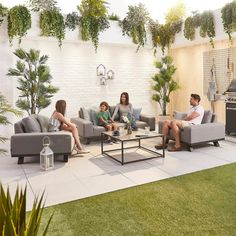 a family sitting on couches in an outdoor living room