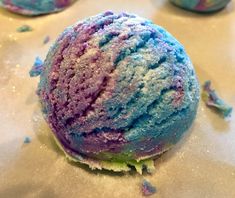 some kind of blue and purple ice cream with sprinkles on the surface