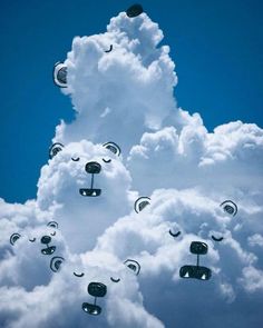 the sky is filled with clouds and many kites in the shape of animals'heads