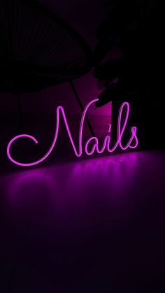 a purple neon sign that says nails on it