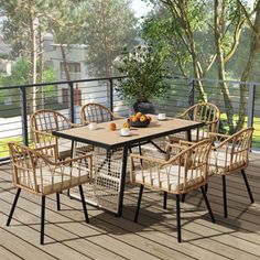 an outdoor table and chairs on a deck