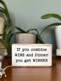 a wooden sign that says if you combine wine and dinner, you get winner