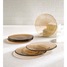 three plates and one bowl are sitting on the table