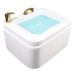 a white sink with a gold faucet and blue water in the bottom basin