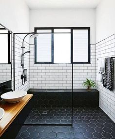 a black and white tiled bathroom with two sinks