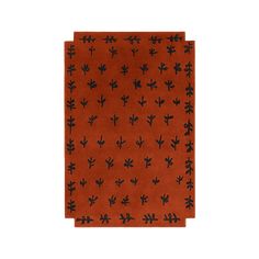 an orange rug with black designs on the front and back of it, against a white background