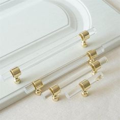 three pairs of gold - plated glass door handles